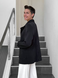 CARAUCCI Urban Lounge unstructured double-breasted black Bamboo Fleece jacket shown with cream flare pants #color_black