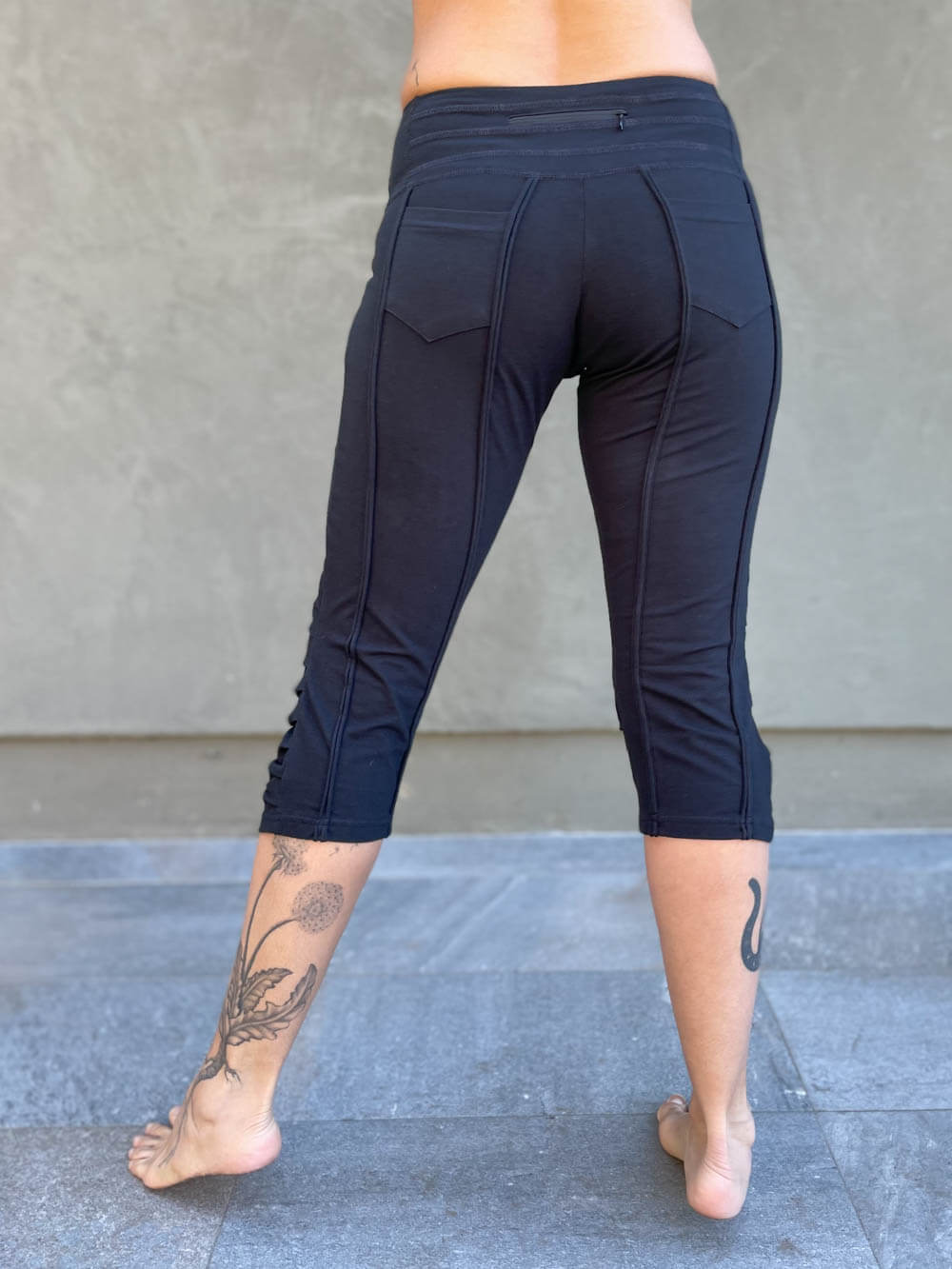 women's cotton lycra stretchy black capri leggings with ruched knees and raised detail stitching #color_black