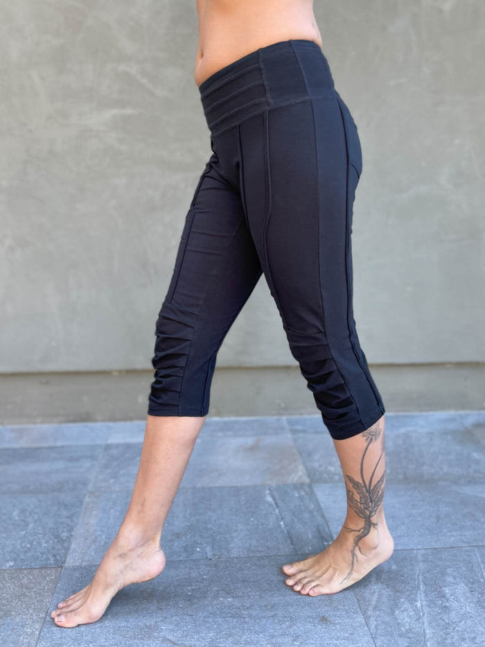 women's cotton lycra stretchy black capri leggings with ruched knees and raised detail stitching #color_black