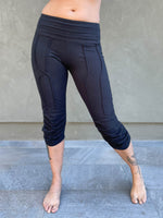 women's cotton lycra stretchy black capri leggings with ruched knees and raised detail stitching #color_black