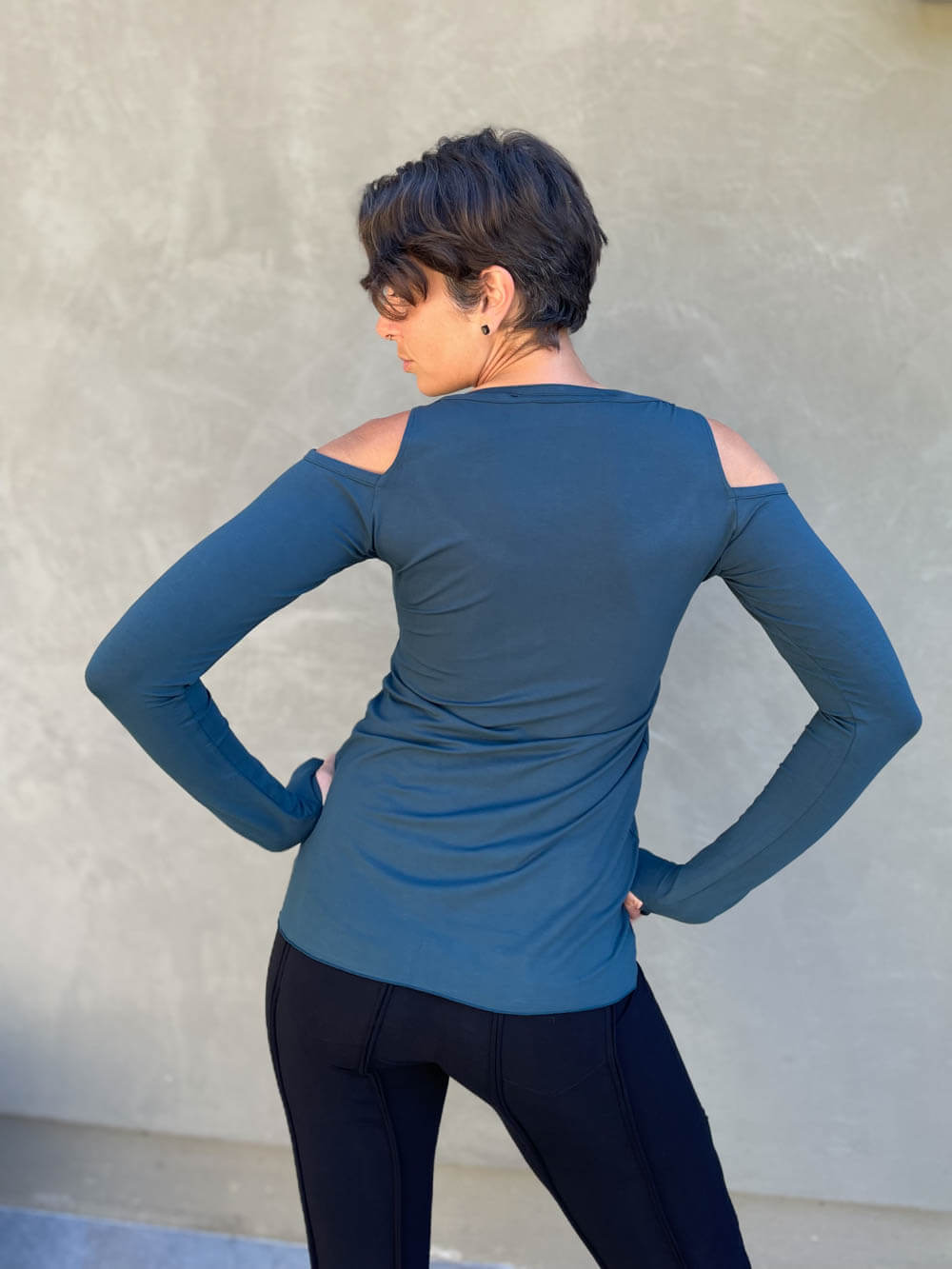 women's plant based stretchy rayon jersey long sleeve peekaboo shoulder teal blue top with thumbholes #color_teal