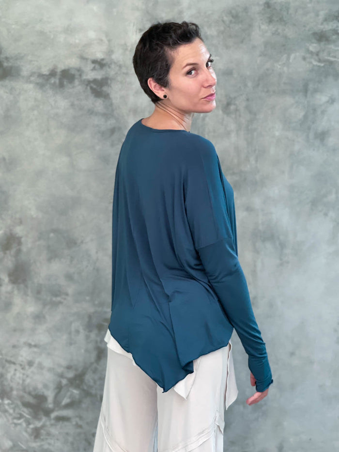 caraucci plant-based rayon jersey teal blue asymmetrical hem oversized long sleeve top with thumbholes #color_teal