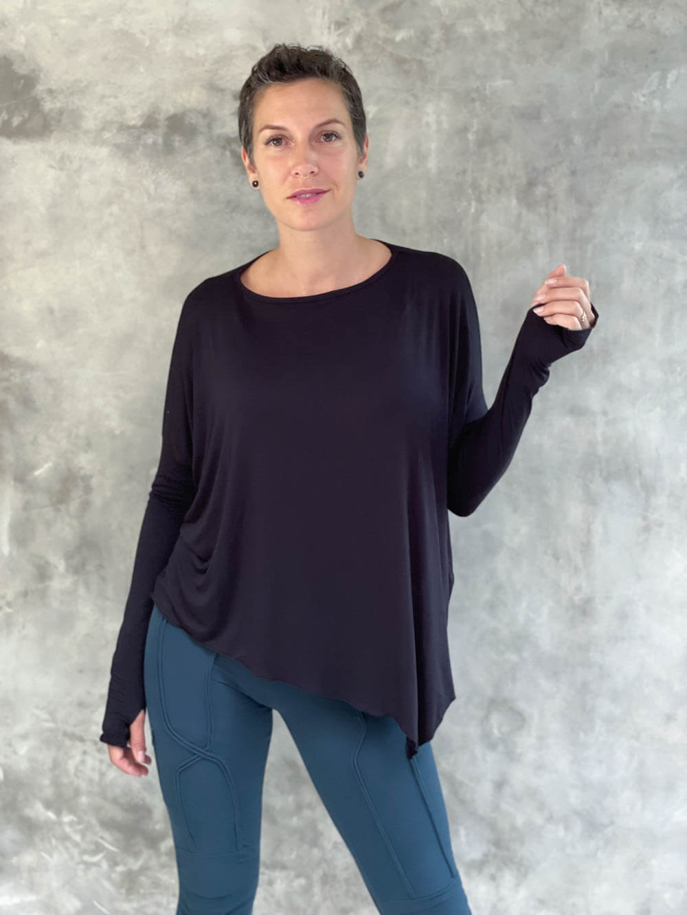 caraucci plant-based rayon jersey black asymmetrical hem oversized long sleeve top with thumbholes #color_black