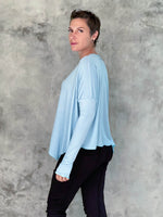 caraucci plant-based rayon jersey sky blue asymmetrical hem oversized long sleeve top with thumbholes #color_canal-blue